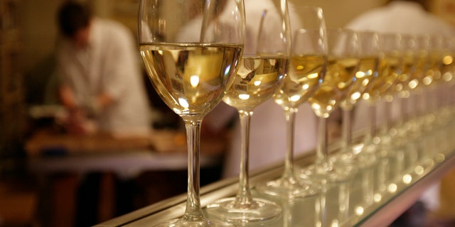File photo - Glasses of white wine are lined up for students to drink at the end of their evening butchery class at the Ginger Pig butchery shop in central London August 25, 2009. (REUTERS/Simon Newman)