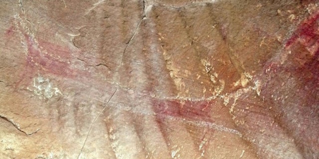 A close-up view of the other "wing." Notice the white chalk lines that were added in the 1940s, and may have been re-chalked since then. Researchers originally used chalk to help visualize the rock art, but the practice is now illegal.