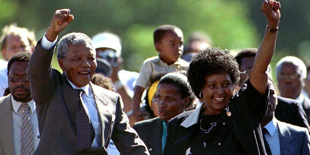 Nelson Mandela and wife Winnie, walk hand in hand, raising their clenched fists upon his release from Victor prison, Cape Town, 27 years in detention.