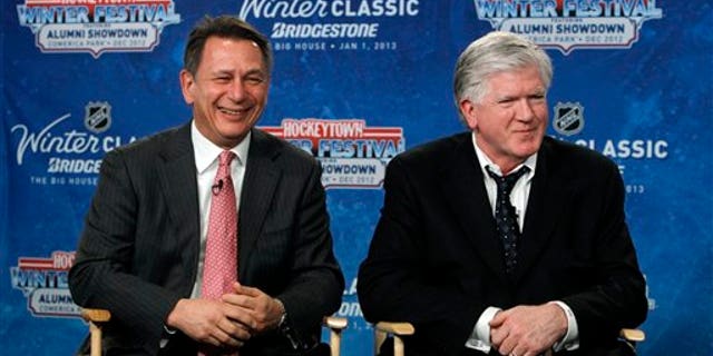 Feb. 9, 2012: Detroit Red Wings general manager Ken Holland, left, and Toronto Maple Leafs President & General Manager Brian Burke speak at a news conference to announce the NHL Winter Classic hockey game at Comerica Park in Detroit. The Toronto Maple Leafs will play the Detroit Red Wings at Michigan Stadium in Ann Arbor, Mich., on Jan. 1, 2013.