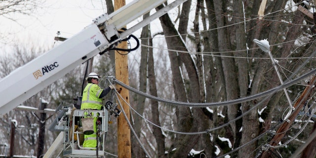 Crews work to replace utility poles in Fairless Hills, Pa. on Thursday, March 8, 2018.