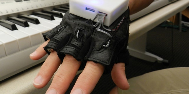 The glove, which looks like a workout glove with a small box on the back, is used with a piano keyboard and vibrates a persons fingers to indicate which keys to play. While learning to play the instrument, several people with SCI experienced improved sensation in their fingers.