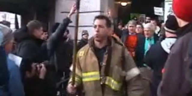 March 1, 2011: Protesters clear a path for firefighters to escort Sen. Glenn Grothman to an underground entrance to the Capitol.