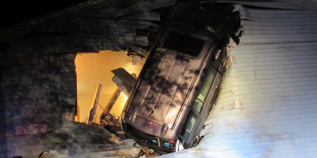 Firefighters in Wisconsin found a minivan embedded in the side of home after responding to a report of an accident.