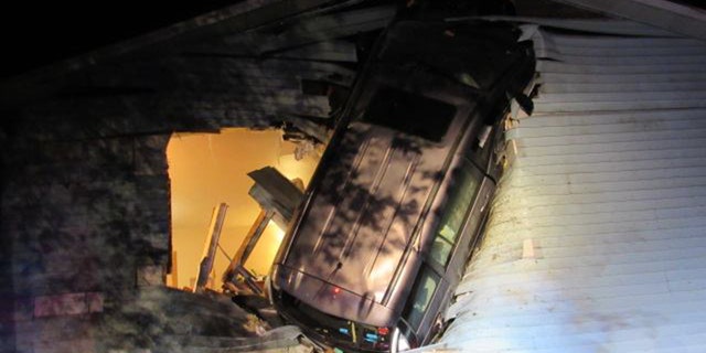 Firefighters in Wisconsin found a minivan embedded in the side of home after responding to a report of an accident.
