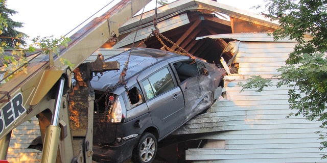 Scene after a minivan crashed into a Wisconsin home.
