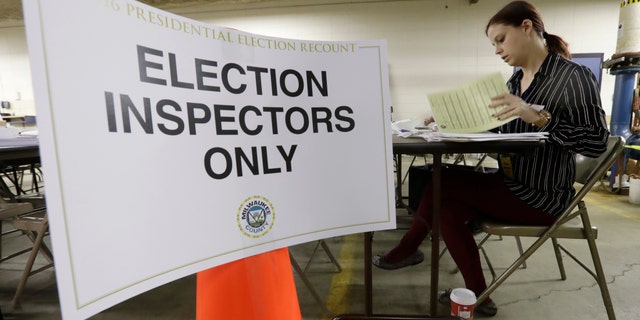 Nicole Kirby looks over results during a statewide presidential recount in Wisconsin