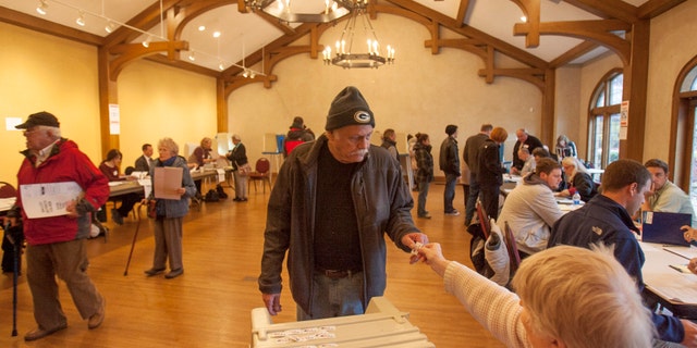 FILE: Voters at the Charles Allis Museum cast their ballots for the U.S. presidential election in Milwaukee, Wisconsin.