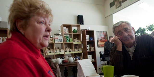 In this March 2, 2011 photo, Nancy, left, and her husband Harry Harrington talk about the Wisconsin budget crisis at Wilson's Coffee &amp; Tea in Racine, Wis. There once was time when the Harrington's walked the picket line outside the nursing home where she was a medical aide, protesting the lack of a pension plan for the unionized work force. But those days of family solidarity are gone. Harry now blames years of union demands for an exodus of manufacturing jobs from this blue-collar city on the shore of Lake Michigan.
