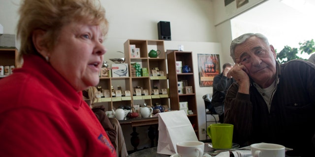 In this March 2, 2011 photo, Nancy, left, and her husband Harry Harrington talk about the Wisconsin budget crisis at Wilson's Coffee & Tea in Racine, Wis. There once was time when the Harrington's walked the picket line outside the nursing home where she was a medical aide, protesting the lack of a pension plan for the unionized work force. But those days of family solidarity are gone. Harry now blames years of union demands for an exodus of manufacturing jobs from this blue-collar city on the shore of Lake Michigan.