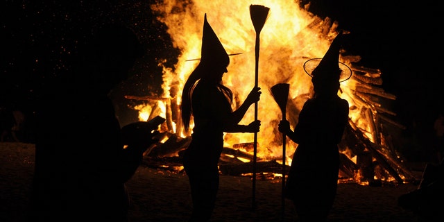 File photo: Two women dressed up as witches take pictures in front of the bonfire during the traditional San Juan's (Saint John) night on the beach in Gijon, northern Spain, June 24, 2015. (REUTERS/Eloy Alonso TPX)