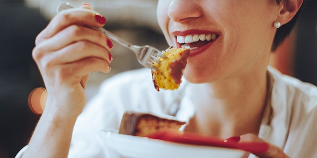 woman eating cake istock