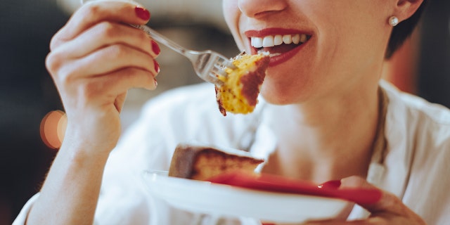 woman eating cake istock