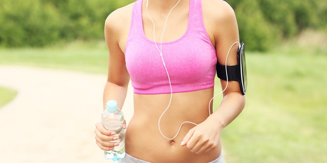 woman in a sports bra walking workout istock medium