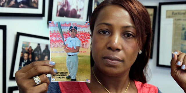 Maribel Martinez holds a photo of her son Andy at her attorney's office, in the Brooklyn borough of New York, Thursday, Sept. 1, 2016. Martinez says she hasn't stopped crying since JetBlue airlines mistook her 5-year-old for another child and flew him to the wrong city. (AP Photo/Richard Drew)