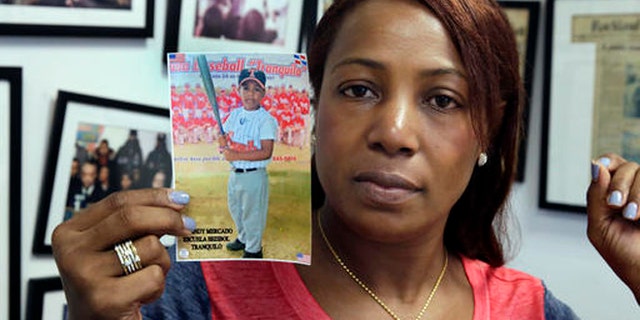 Maribel Martinez holds a photo of her son Andy at her attorney's office, in the Brooklyn borough of New York, Thursday, Sept. 1, 2016. Martinez says she hasn't stopped crying since JetBlue airlines mistook her 5-year-old for another child and flew him to the wrong city. (AP Photo/Richard Drew)