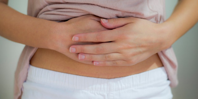 woman with hand on her stomach