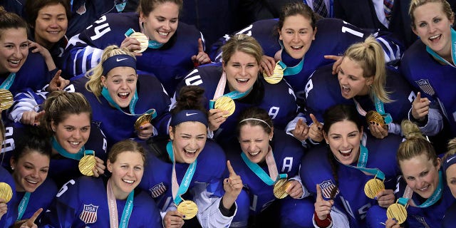The United States hockey team celebrate with their gold medals after beating Canada in the women's gold medal hockey game at the 2018 Winter Olympics.