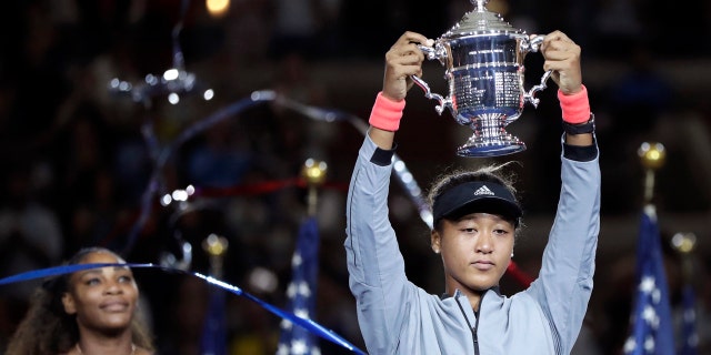 aomi Osaka, of Japan, holds the trophy after defeating Serena Williams in the women's final of the U.S. Open tennis tournament, Saturday, Sept. 8, 2018, in New York.