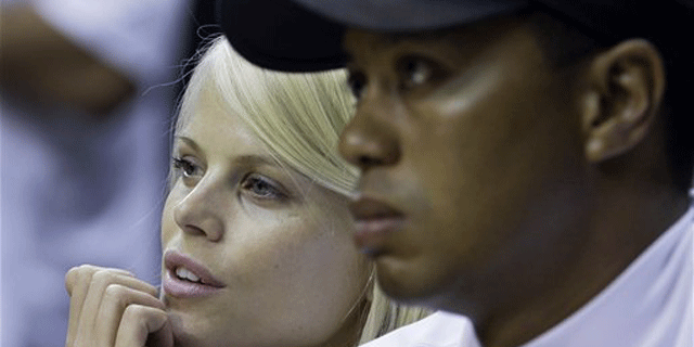 FILE: Tiger Woods and wife Elin Nordegren are seen talking in this June 11, 2009 photo during the first quarter of the NBA finals in Orlando, Fla. (AP)