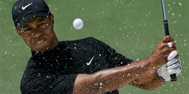 In this April 11, 2008, file photo, Tiger Woods hits out of a bunker on the second hole at the Augusta National Golf Club. (AP Photo)