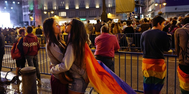 Women embrace while attending a concert in the Plaza Puerta del Sol, Friday, June 30, 2017 in Madrid. The city is celebrating WorldPride 2017, a colorful mixture of vindication for sexual and gender diversity and all-night partying. Up to 3 million people are expected in the Spanish capital amid tight security measures. (AP Photo/Mark Lennihan)