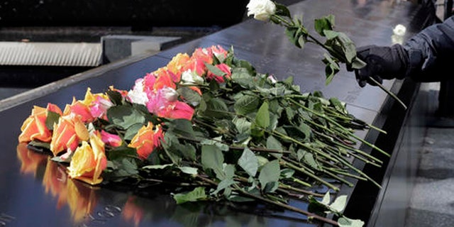 A rose is placed on the 9/11 Memorial during a ceremony commemorating the 23rd anniversary of the 1993 World Trade Center bombing that killed six people and injured more than 1,000, in New York, Friday, Feb. 26, 2016. (AP Photo/Richard Drew)