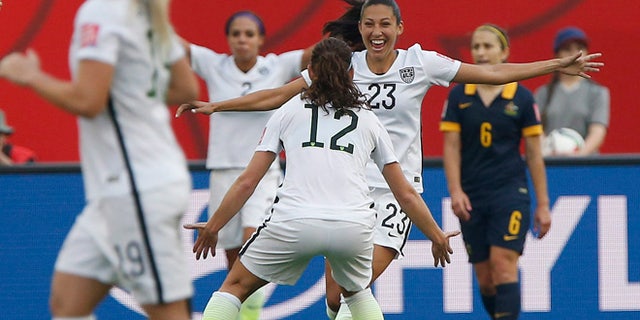 June 8, 2015: United States' Christen Press (23) celebrates her goal against Australia with Lauren Holiday (12) during a FIFA Women's World Cup soccer match in Winnipeg, Manitoba.