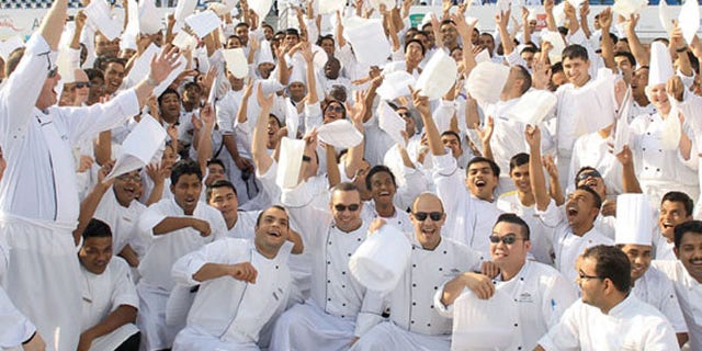 Happy chefs in white after setting a new world record for the largest chef gathering.