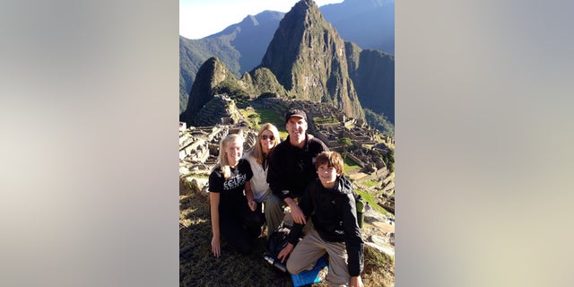 A family poses while hiking the Salkantay Trek, Machu Picchu.