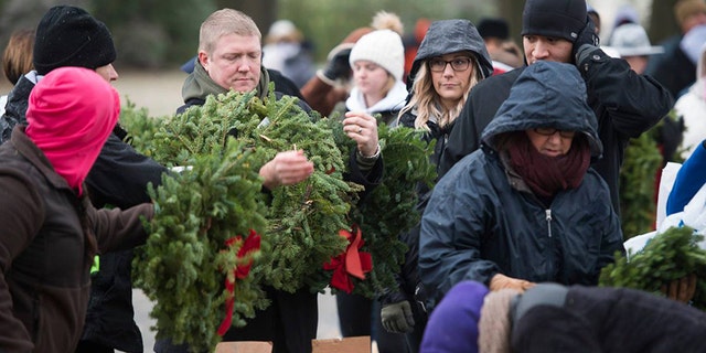 Each year, Wreaths Across America helps to place a holiday wreath on the tomb of each fallen soldier at Arlington National Cemetery in remember of U.S. veterans.
