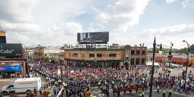 Protesters arrive at Wrigley Field to demand more government action against gun violence, Thursday, Aug. 2, 2018, in Chicago.