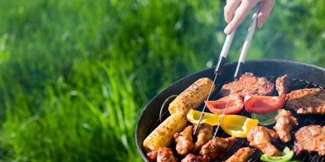 Grilling at summer weekend. Fresh meat and vegetables preparing on grill.