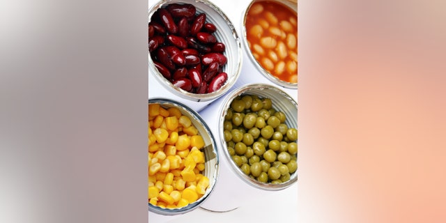 Four Open Cans of Vegetables with Corn, Green Pea, White and Red Runner Bean.
