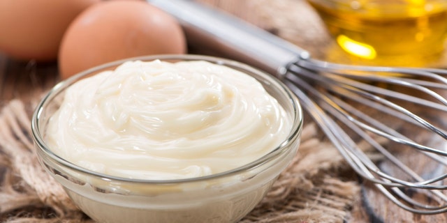 Fresh Mayonnaise (homemade) on an old wooden table