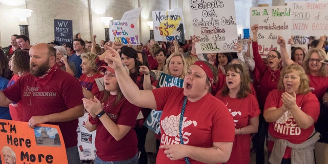 Teachers and school personnel rally at the Capitol building in Charleston on Feb. 27.