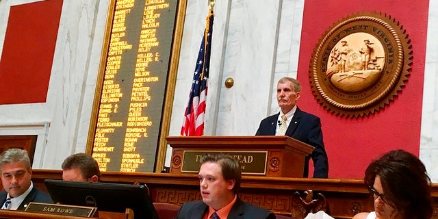 West Virginia House Speaker Pro Tempore John Overington, top, presides over the start of a hearing Monday, Aug. 13, 2018, at the state Capitol in Charleston, W. Va. The House of Delegates is considering the impeachment of the entire state Supreme Court in a scandal over $3.2 million in office renovations. (AP Photo/John Raby)