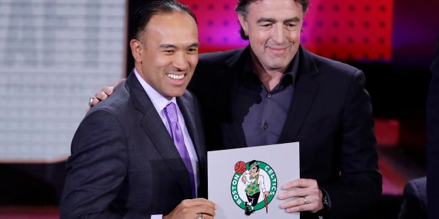 NBA Deputy Commissioner Mark Tatum, left, poses for photographs with Boston Celtics co-owner Wyc Grousbeck, right, after the Celtics won the first pick in the NBA basketball draft, at the draft lottery Tuesday, May 16, 2017, in New York. (AP Photo/Frank Franklin II)