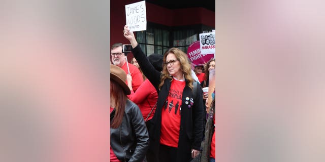 Elizabeth Perkins joined a Me Too protest and held up a sign that said, "James Woods #MeToo."
