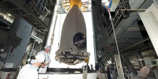 The Air Force's robotic X-37B space plane, encapsulated in its fairing, being readied for attachment to its Atlas V rocket ahead of a planned May 20, 2015 launch.