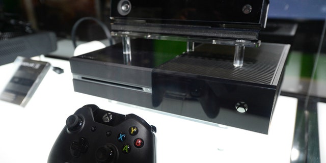 In this Aug. 28, 2013, file photo, the Microsoft Xbox One console, shown with Kinect, is on display at the GameStop Expo in Las Vegas.