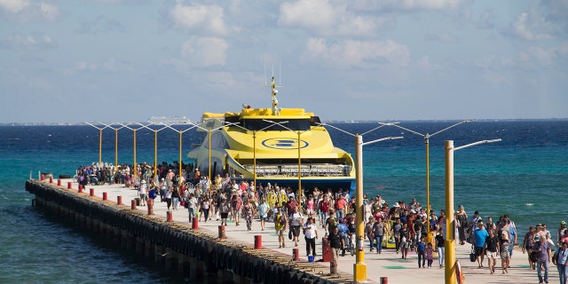 Tourists and passengers disembark from a ferry on to the wharf on Playa del Carmen, Mexico, Friday, March 2, 2018. Undetonated explosives were found on another ferry that runs between the Caribbean resorts of Playa del Carmen and the island of Cozumel, authorities said, less than two weeks after a blast shook another ferry plying the same route.