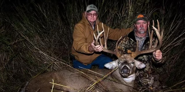 Denis and Don Higgins pose with Smokey.