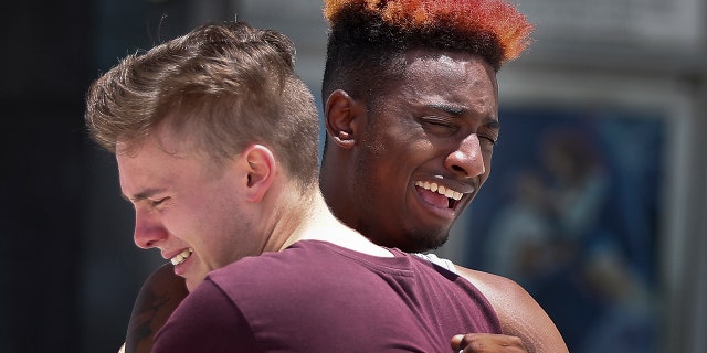 D Bouey, 21, of Orlando, Fla., right, cries with his friend after a memorial for the rapper, XXXTentacion, Wednesday, June 27, 2018, in Sunrise, Fla.