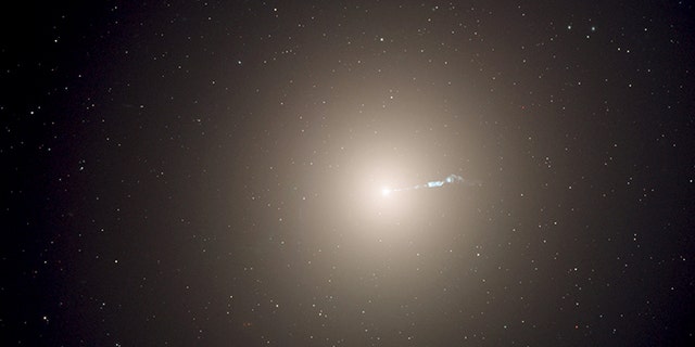 The monstrous elliptical galaxy M87, located 53 million light-years from Earth is the dominant galaxy at the center of the neighboring Virgo cluster of galaxies. Astronomers have measured the "heartbeats" of stars within M87 and used that data to determine the galaxy's age in a new way. This photograph was taken with the Hubble Space Telescope's Advanced Camera for Surveys instrument. (NASA, ESA, and the Hubble Heritage Team)
