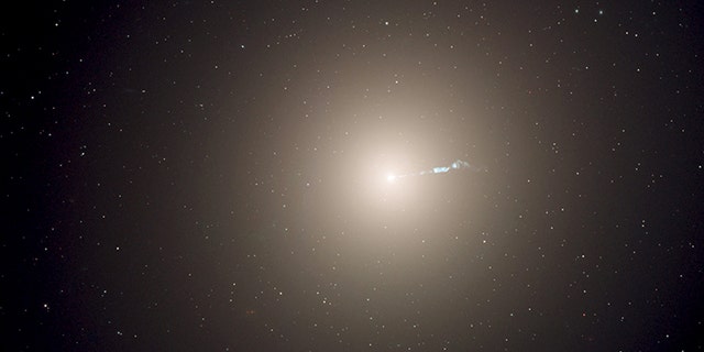 The monstrous elliptical galaxy M87, located 53 million light-years from Earth is the dominant galaxy at the center of the neighboring Virgo cluster of galaxies. Astronomers have measured the "heartbeats" of stars within M87 and used that data to determine the galaxy's age in a new way. This photograph was taken with the Hubble Space Telescope's Advanced Camera for Surveys instrument. (NASA, ESA, and the Hubble Heritage Team)