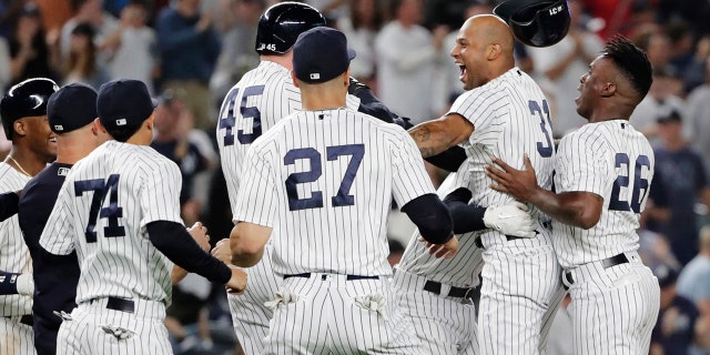 New York Yankees' Aaron Hicks (31) celebrates with teammates after hitting an RBI double during the 11th inning against the Baltimore Orioles in New York, Sept. 22, 2018. The Yankees won 3-2.