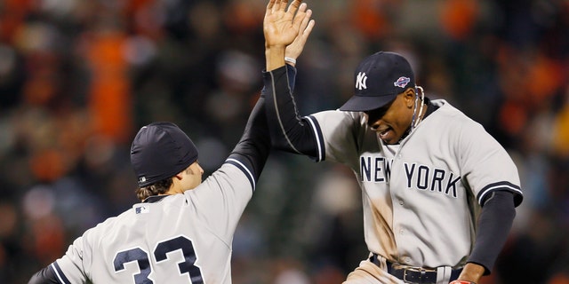BALTIMORE, MD - OCTOBER 07: Nick Swisher #33 of the New York Yankees and teammate Curtis Granderson #14 celebrate after the Yankees defeated the Baltimore Orioles 7-2 during Game One of the American League Division Series at Oriole Park at Camden Yards on October 7, 2012 in Baltimore, Maryland. (Photo by Rob Carr/Getty Images)