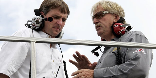 Robert Yates, left, talks to Doug Yates at New Hampshire Motor Speedway in 2006