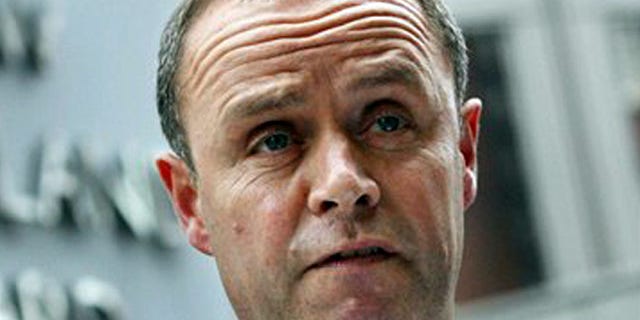 London's Metropolitan Police Assistant Commissioner John Yates stands outside the force's headquarters at New Scotland Yard in London, in this July 9 2009 file photo.
